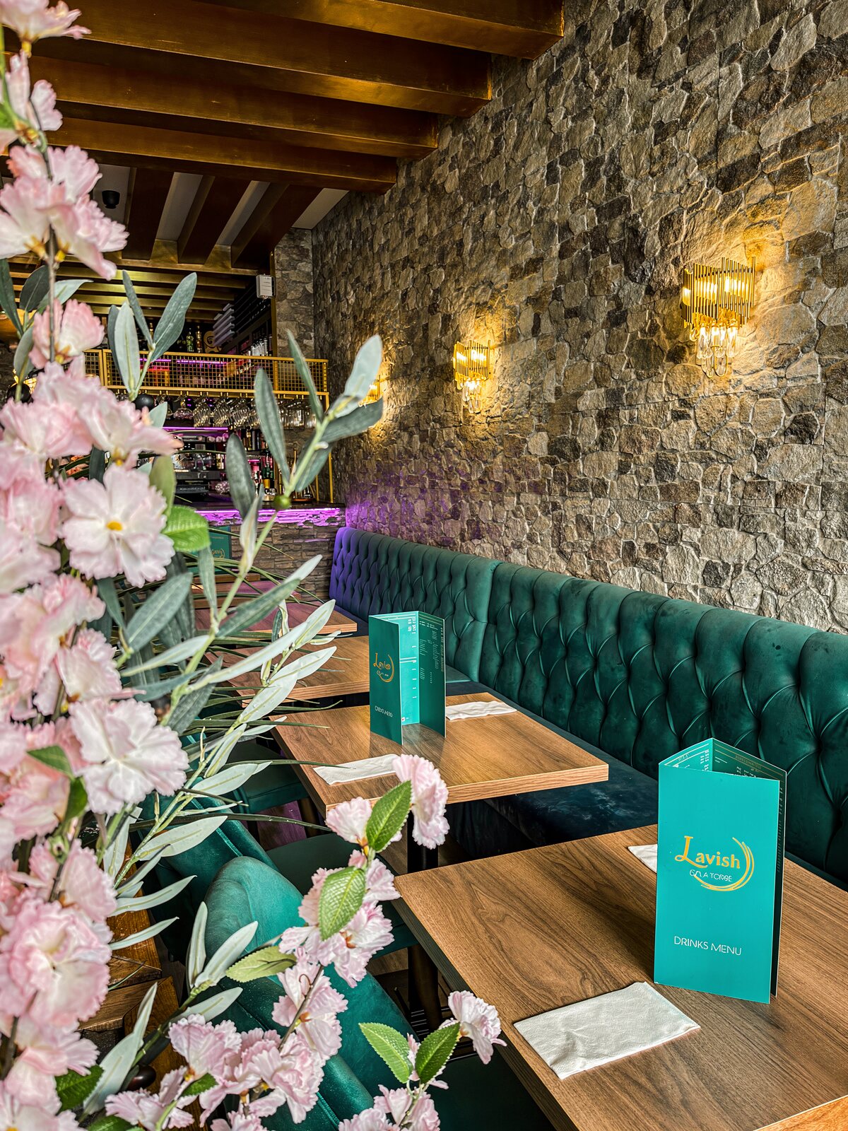 Dining tables with Lavish drinks menus along the banquette
