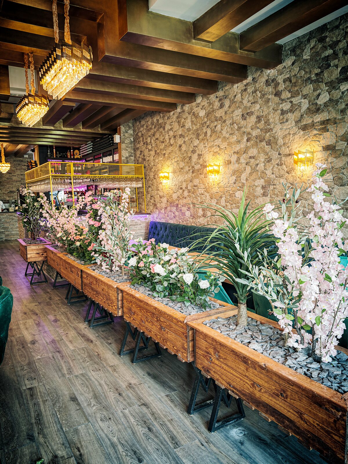 The aisle of planters leading toward the bar