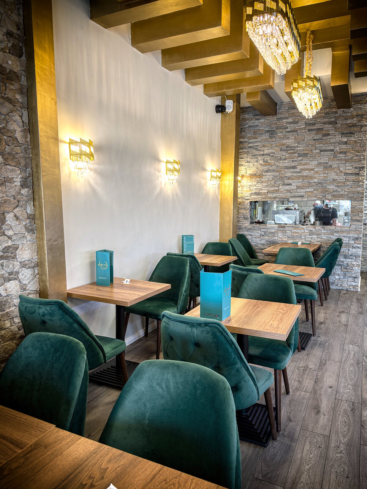 The dining room, with the kitchen pass beyond the stone wall