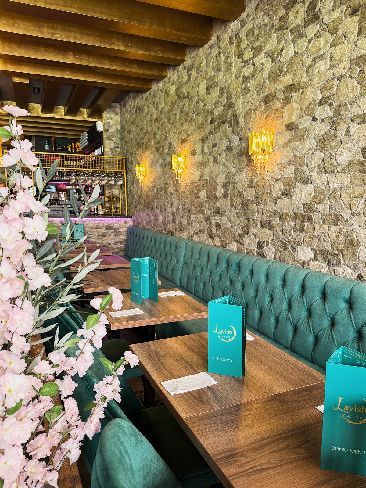 Tables set along the stone wall at Lavish by La Torre