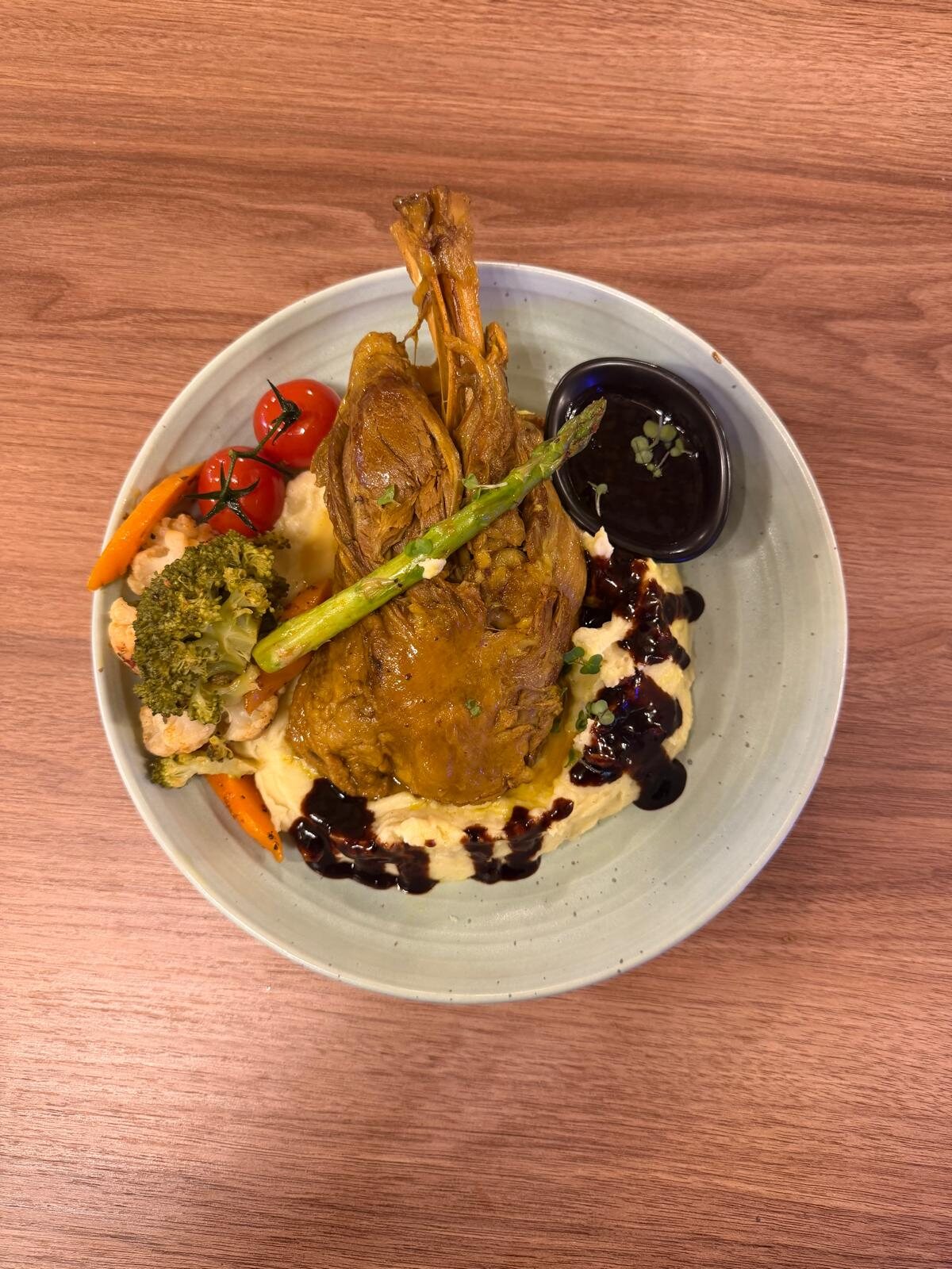 Lamb with mash, greens and a jug of sauce