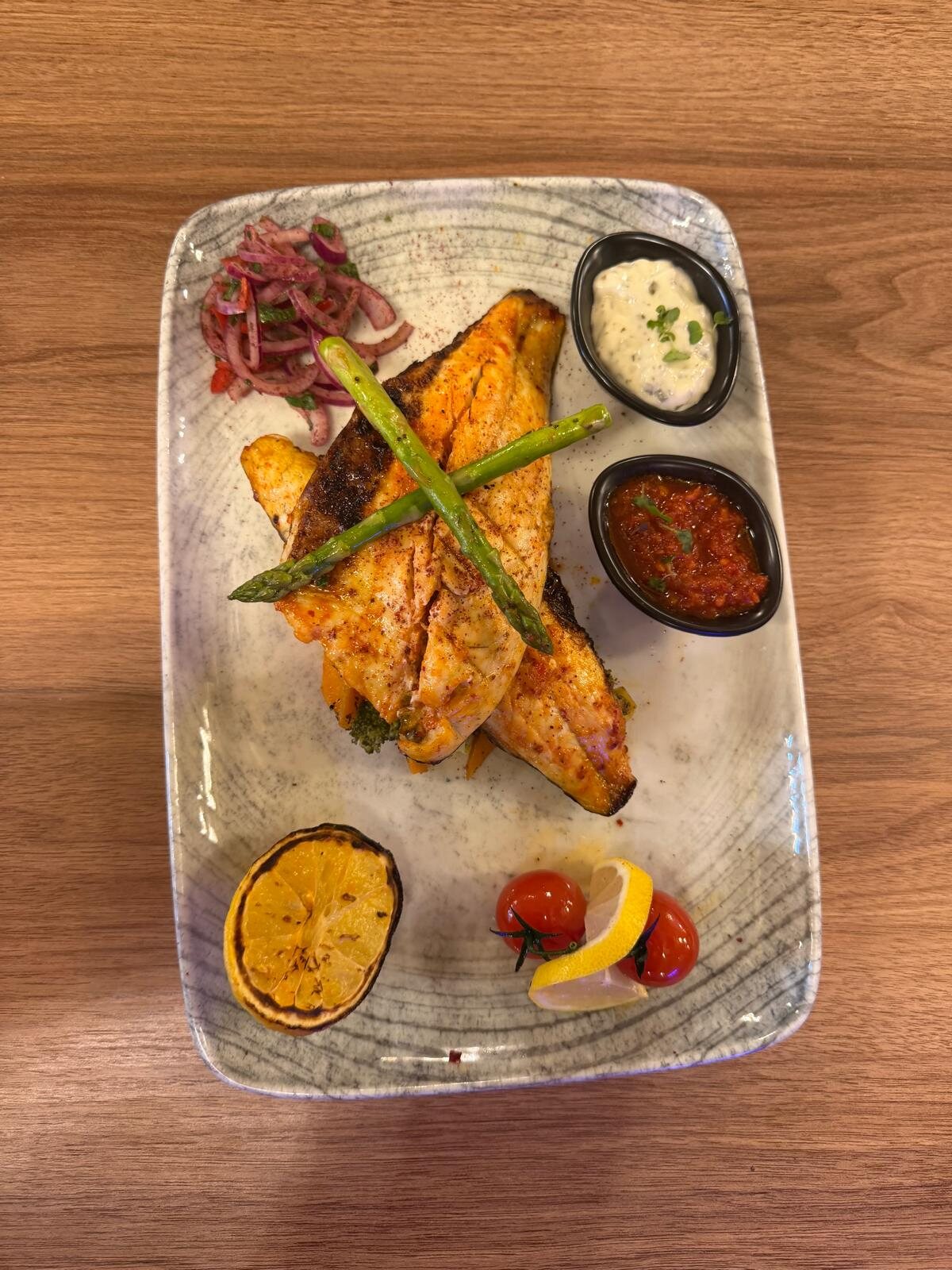 Grilled sea bass with asparagus and sauces